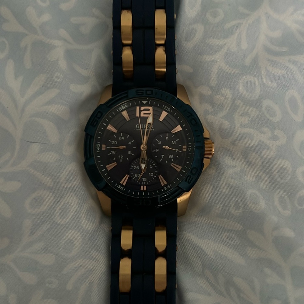 Men’s gold and blue guess watch